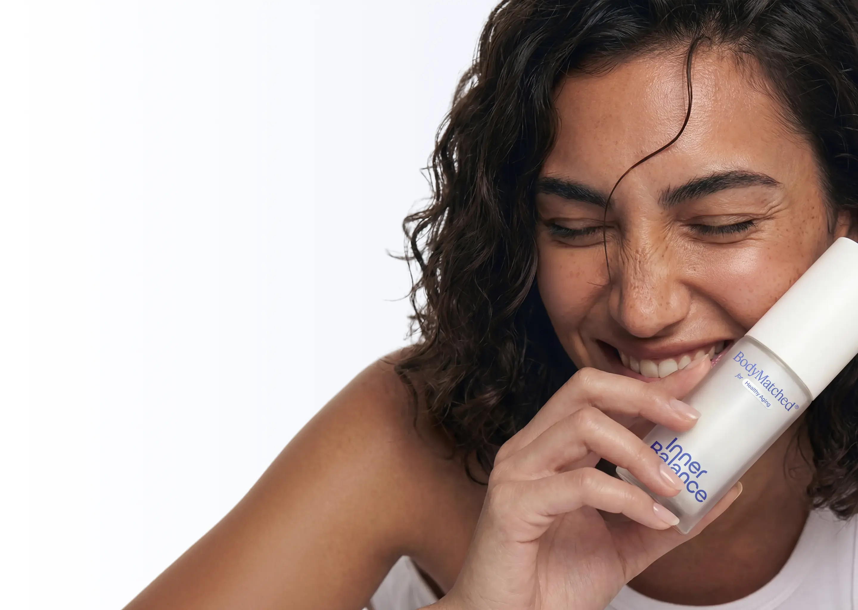 Woman holding BodyMatched® face cream with finasteride