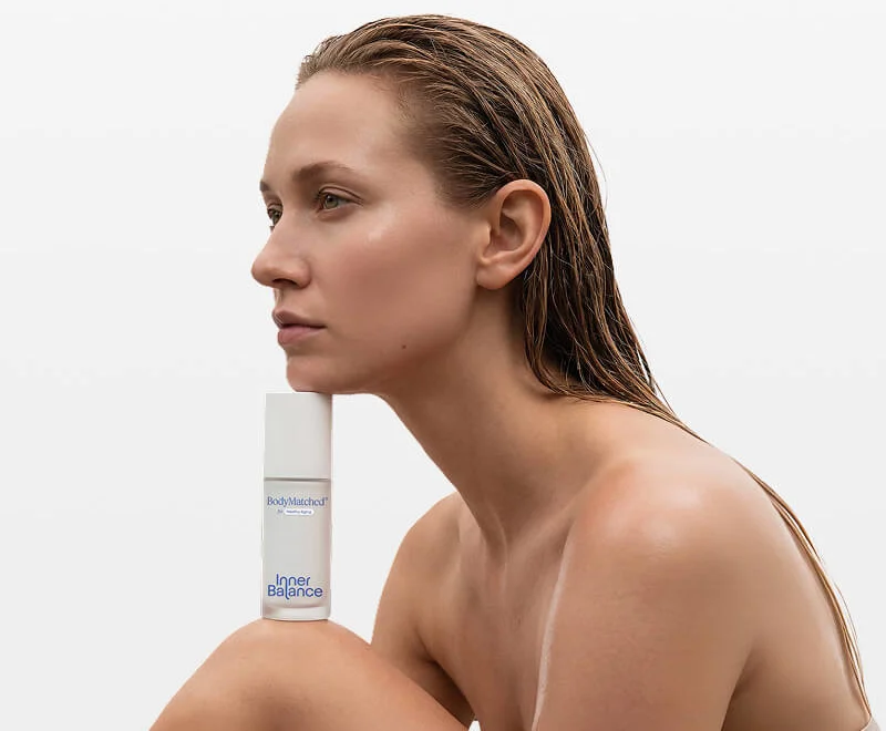 Woman in perimenopause holding BodyMatched® anti-aging face cream