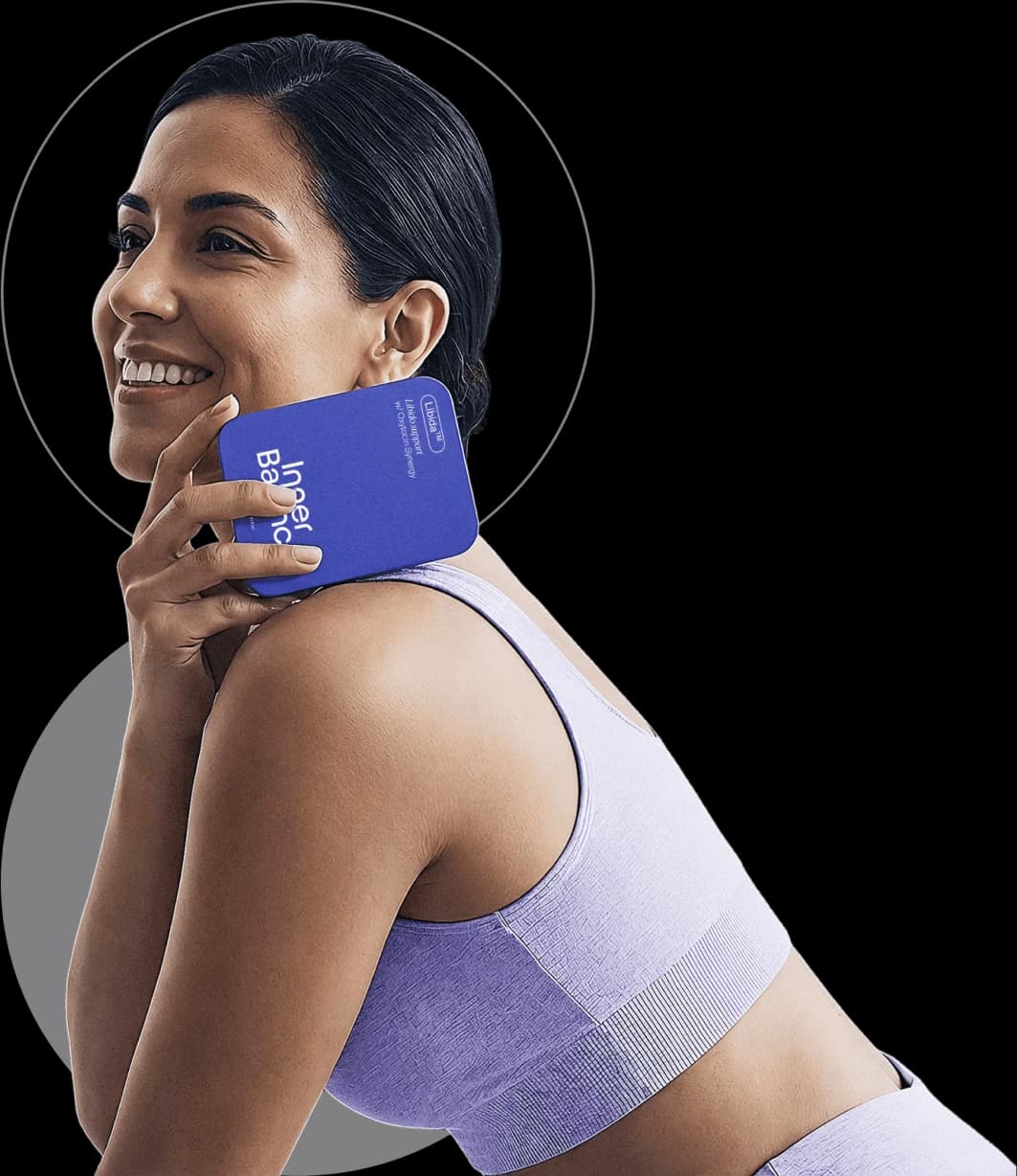 Smiling woman holding an Inner Balance Libida box
