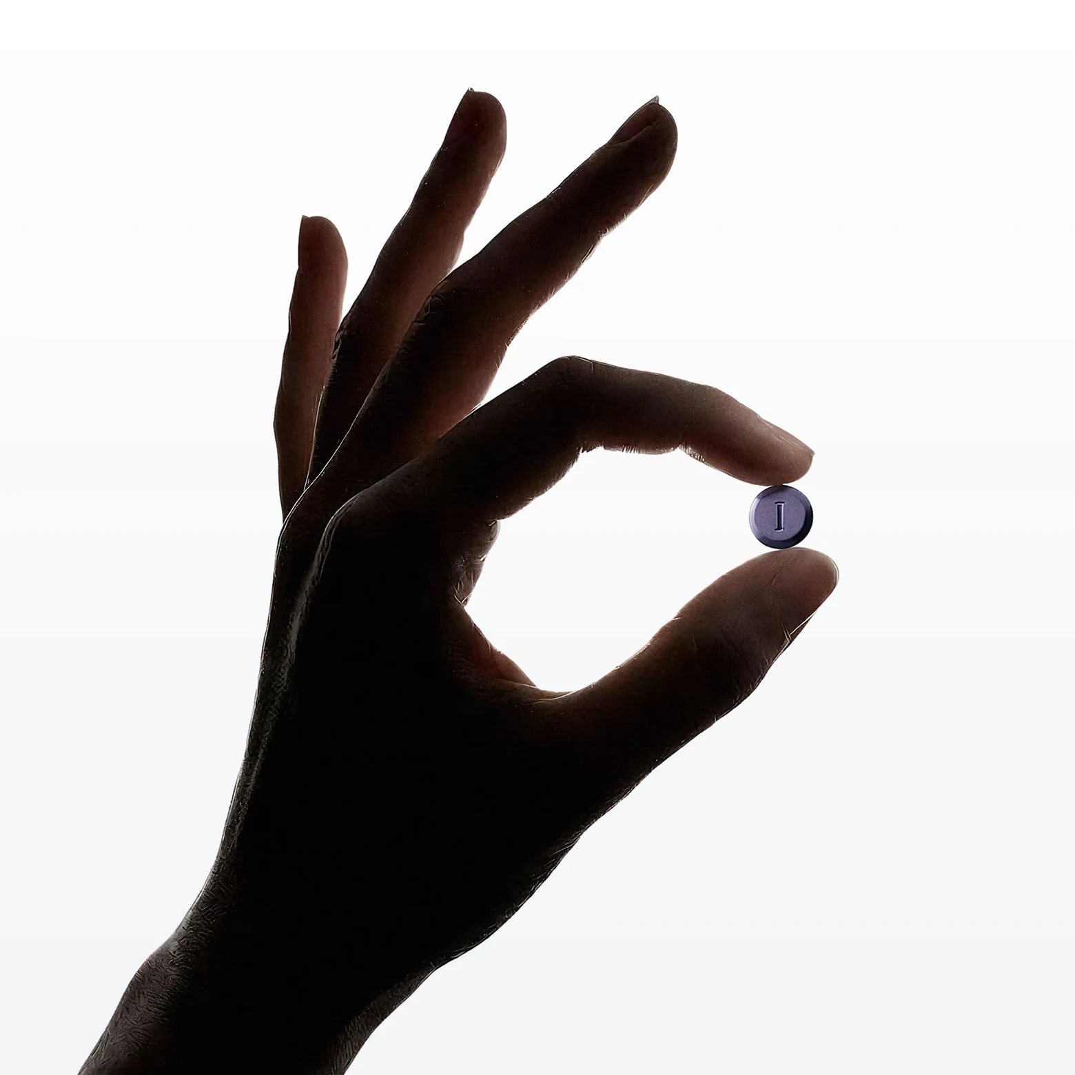 Holding a pill in the hand