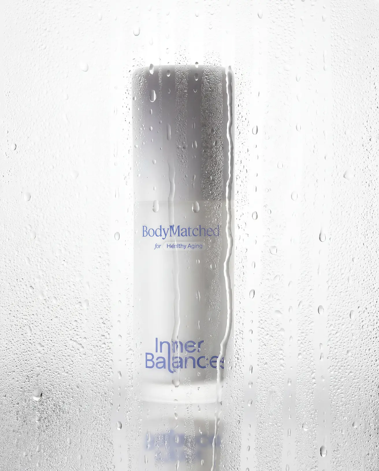 Hand holding a bottle of BodyMatched® face cream