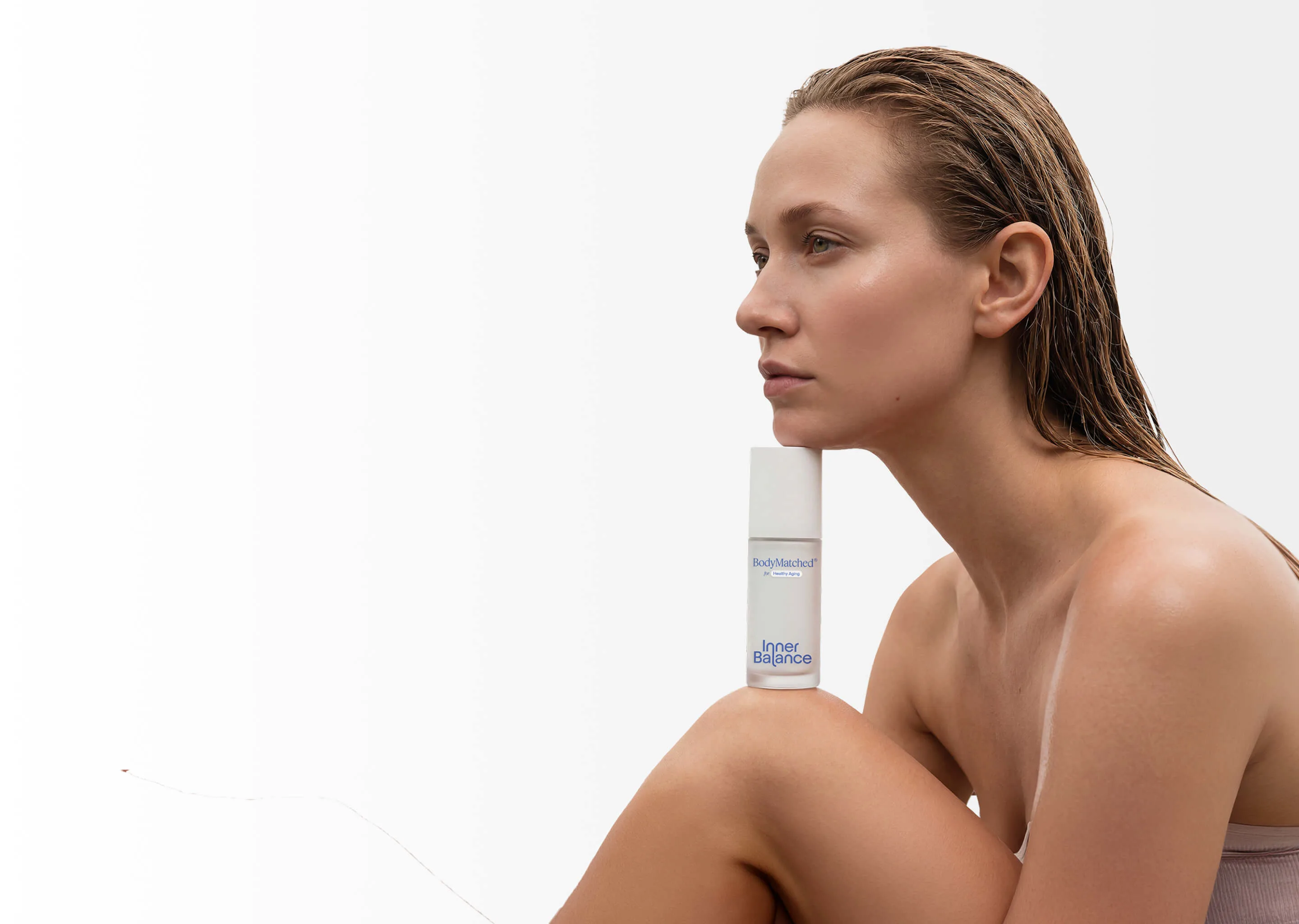 Woman in perimenopause holding BodyMatched® anti-aging face cream