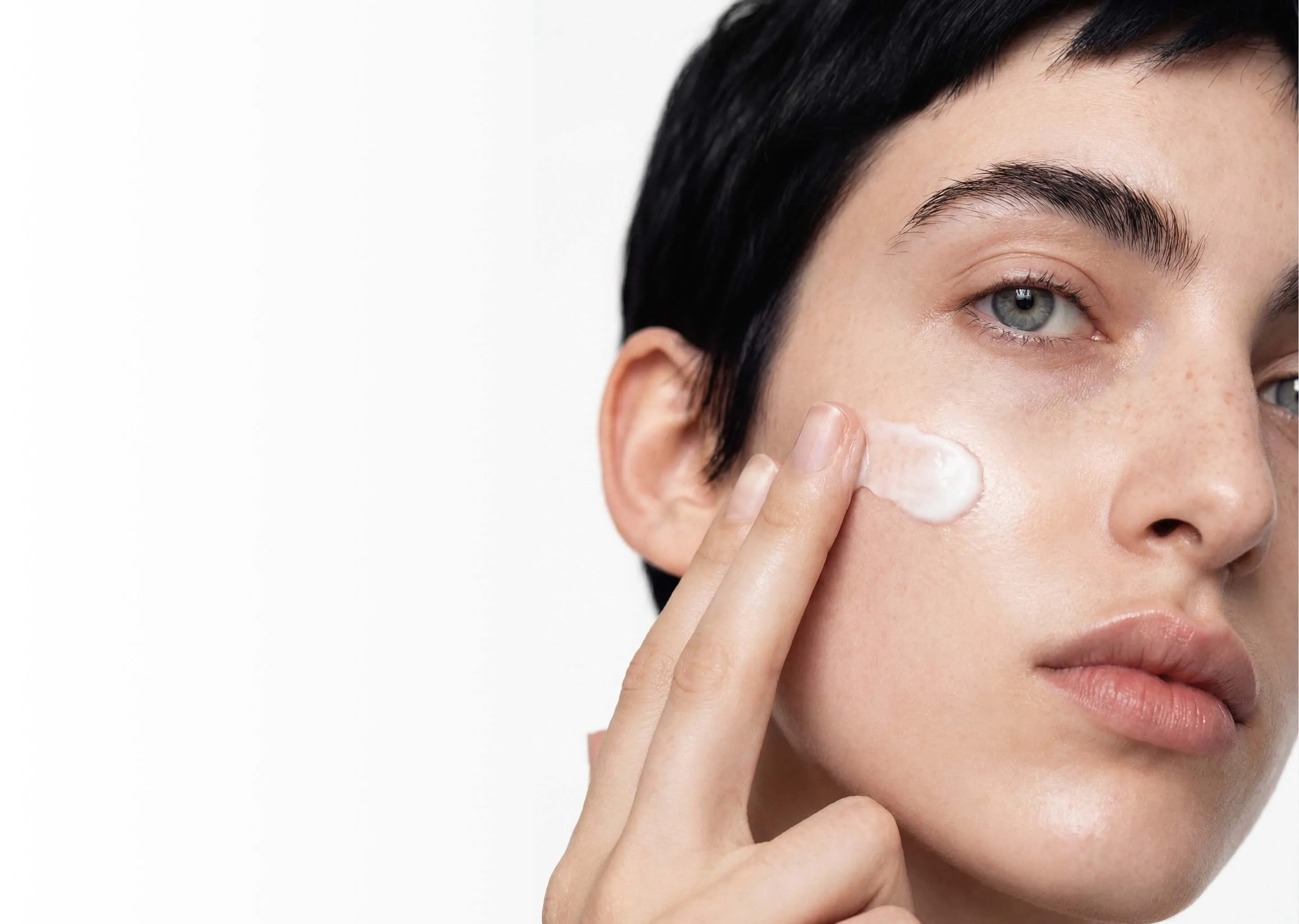 Woman in perimenopause holding BodyMatched® anti-aging face cream